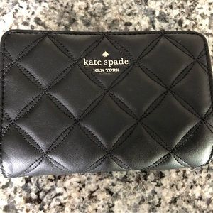 Kate Spade Natalia medium compact bifold wallet in black quilted leather.